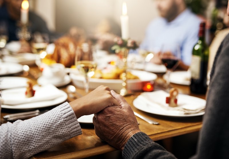 A family joining hands in thanks for Thanksgiving